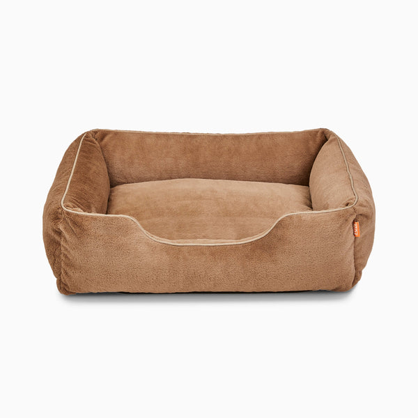 The Sammy bolster dog bed in light brown faux fur by Fuzi, with a removable cover available in four beautiful colors and three sizes.