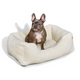 French Bulldog in a Sammy bolster dog bed in white faux fur by Fuzi, washable dog bed, available in four beautiful colors and three sizes.