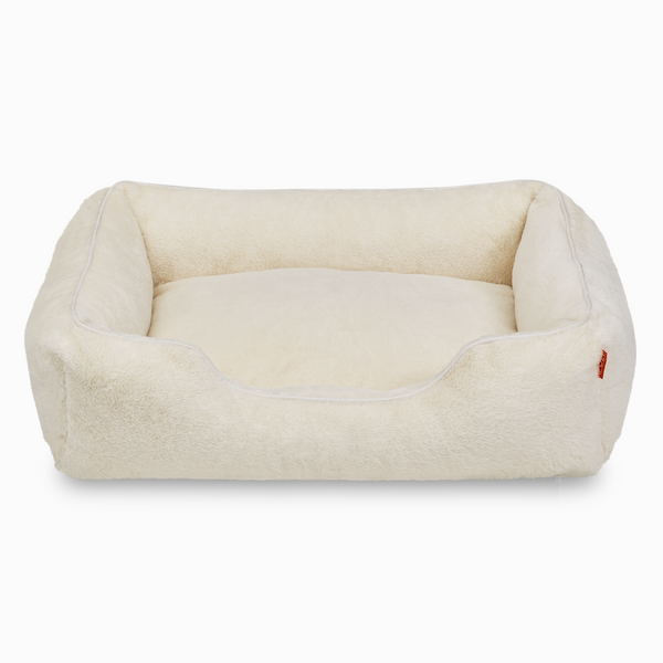 Sammy bolster dog bed in white faux fur by Fuzi, washable dog bed, available in four beautiful colors and three sizes.