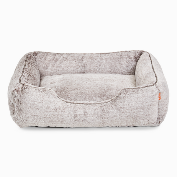 Sammy bolster dog bed in light grey faux fur by Fuzi, with a removable cover available in four beautiful colors and three sizes.