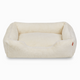 Sammy bolster dog bed in white faux fur by Fuzi, washable dog bed, available in four beautiful colors and three sizes.