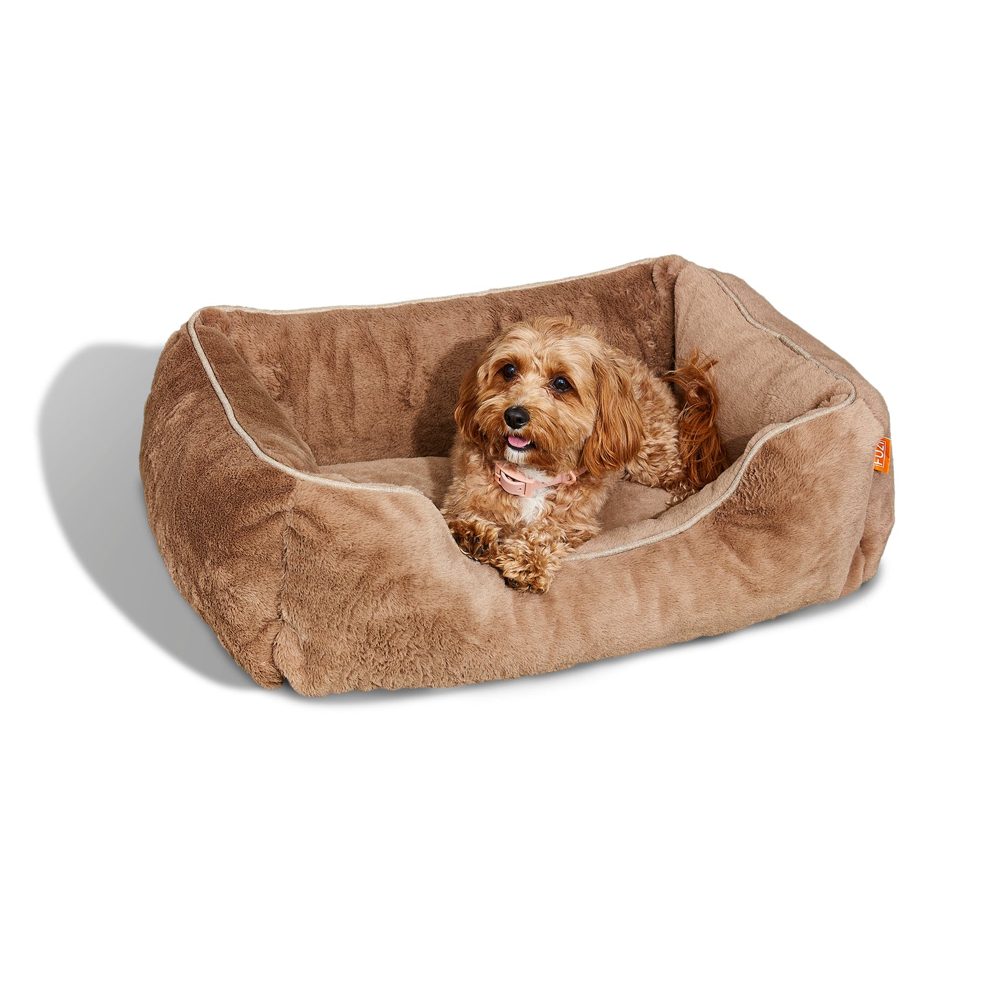 Small size Sammy bolster dog bed by Fuzi with a washable, removable cover in light brown fur