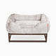 Light grey faux fur window seat dog beds by Fuzi, designed for enhanced airflow, support, and comfort, in light grey fur with a black metal base.