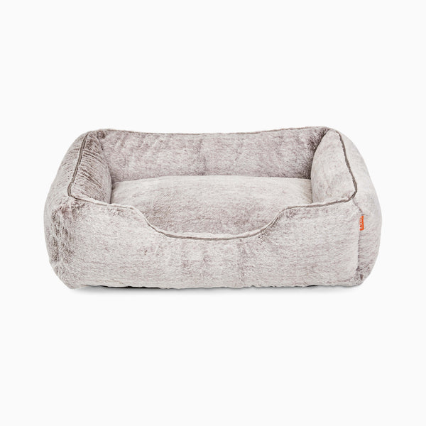 Sammy bolster dog bed in medium light grey faux fur by Fuzi, with a removable cover available in four beautiful colors and three sizes.